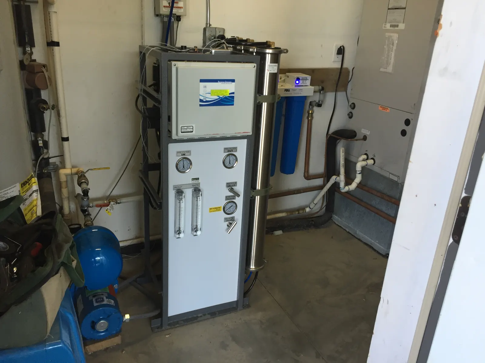 Light-commercial RO skid with pressure gauges and booster pump.