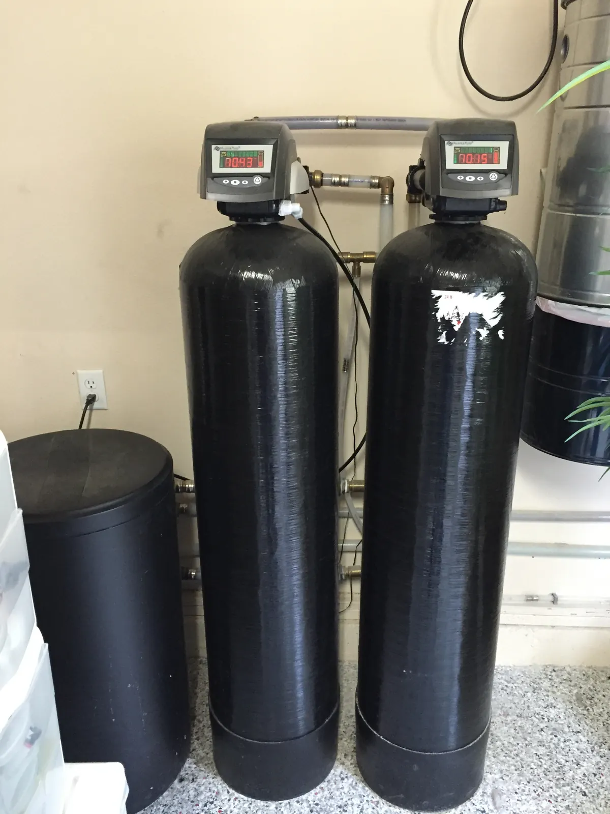 Dual adsorptive media tanks for whole-house arsenic reduction.