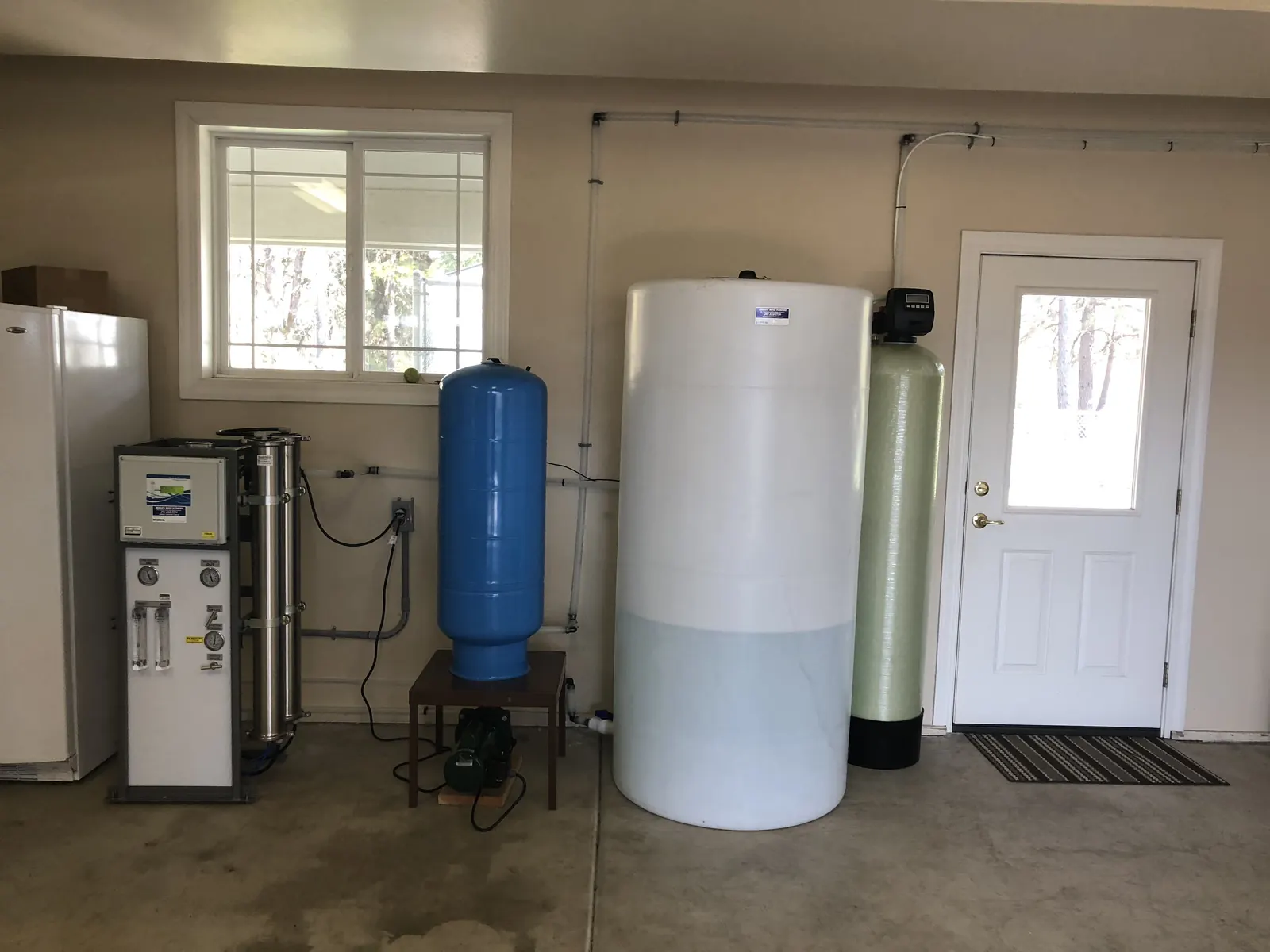 Full Absolute Water Filtration install — RO skid, pressure tank, storage, and softener